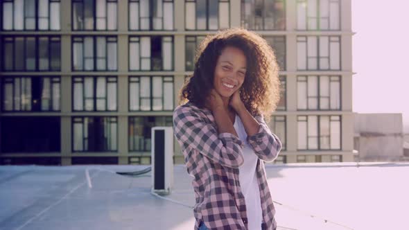 Fashionable young woman on urban rooftop