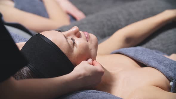 Cute Caucasian Woman Enjoys Getting Facials at the Spa