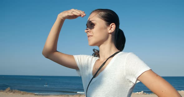 Young Attractive Woman Looking Forward with Blue Sky and Sea As Background