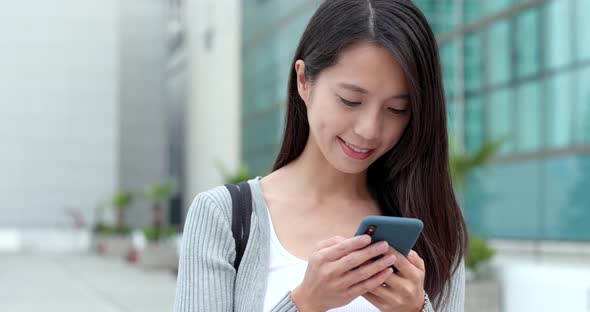 Woman work on cellphone at outdoor