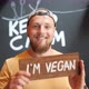 Young Bearded Man Holding Wooden I Am Vegan Sign - VideoHive Item for Sale