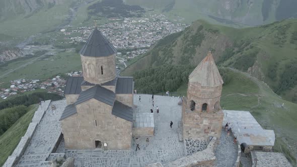 Stepantsminda, Georgia - May 8 2021: Aerial view of Gergeti Trinity Church, Tsminda Sameba. Kazbegi