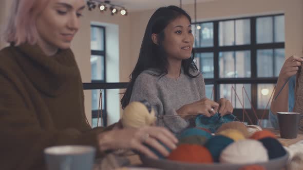 Smiling Girls In A Knitting Lesson