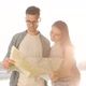 Close up view of Young Couple Hikers in the Wood. Standing by the Lake. Using Tourist Map. - VideoHive Item for Sale