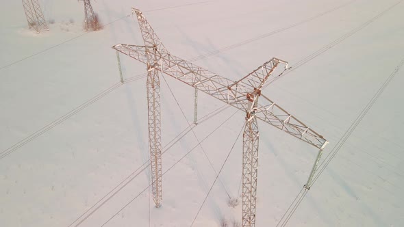 ABOVE VIEW Power Pylons in a Field in Winter