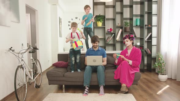 Modern Parents Looks After The Children At Home.