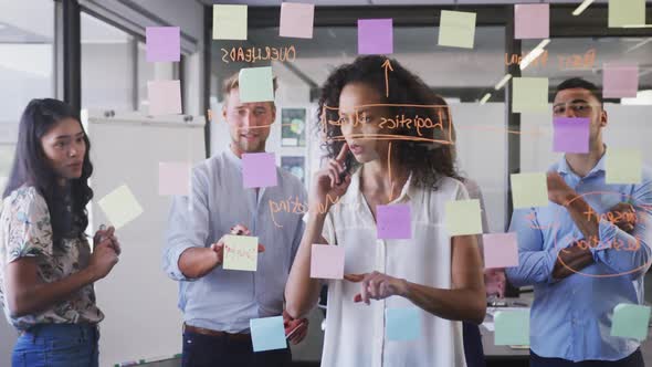 Professional businesswoman writing on glassboard in modern office in slow motion