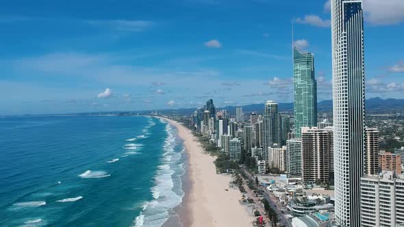High aerial view video capturing the landmark high-rise buildings along the beach front of the Surfe