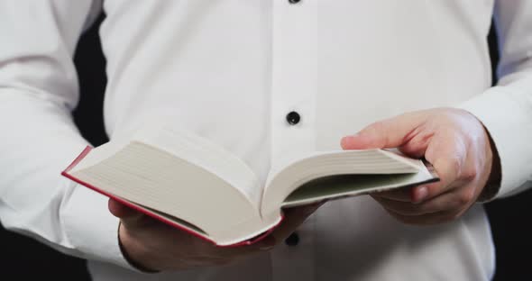 Person reading the pages of a book