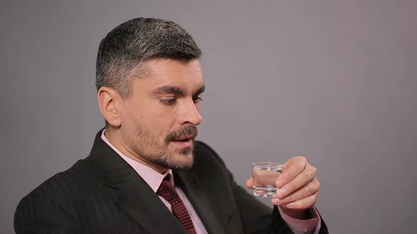 Sad Businessman Drinking Shot of Vodka at Restaurant, Strong Alcoholic Drink