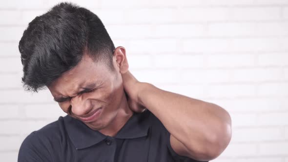Man Suffering From Neck Pain at Home