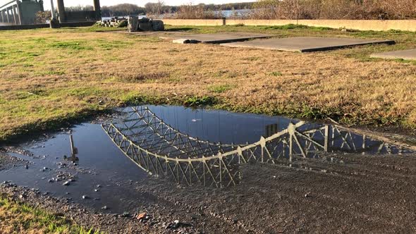 Memphis Bridge Reflection in puddle