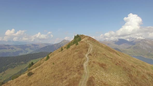 Aerial drone view of an empty hiking biking trail on a mountain hill