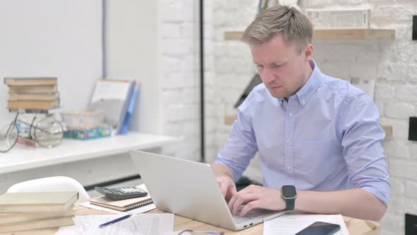 Businessman Working on Laptop in Office
