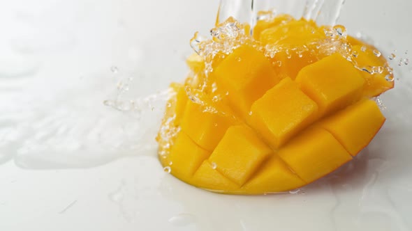 Water splash and mango. Slow Motion.