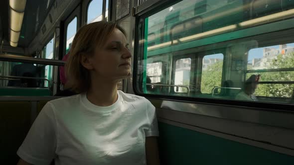 Tourist Woman Riding Metro Train at Paris Looking at Tower and Streets 