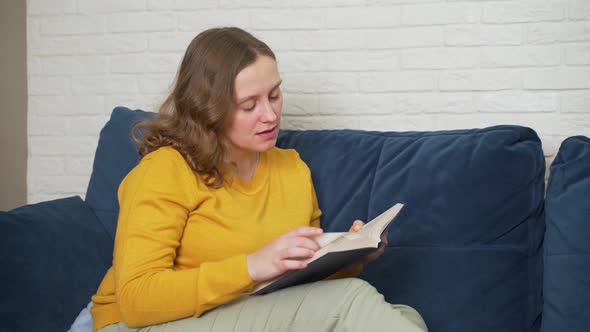 Woman is Enthusiastically Reading Hardcover Paper Book