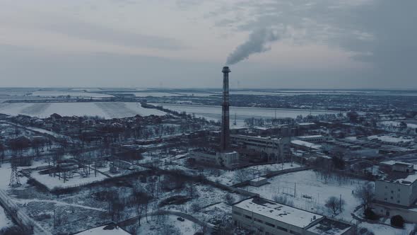 Aerial View of a Boiler Pipe of an Industrial Facility in a Snowy Winter