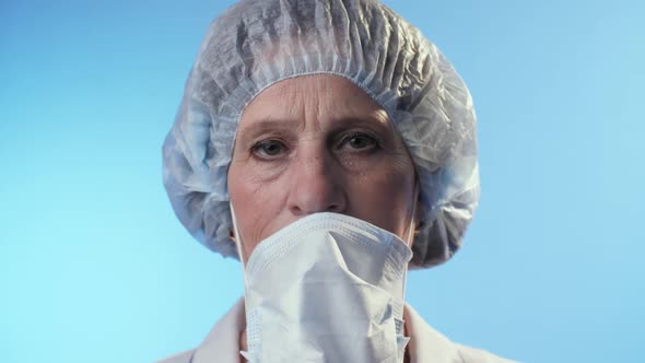 Sad Physician Takes Off a Surgical Mask