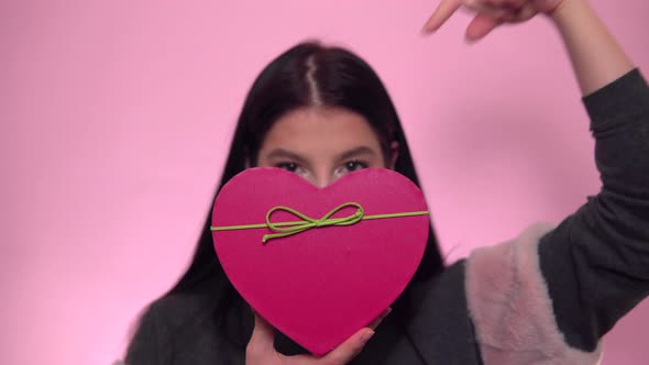 Woman holding preset box in shape of heart