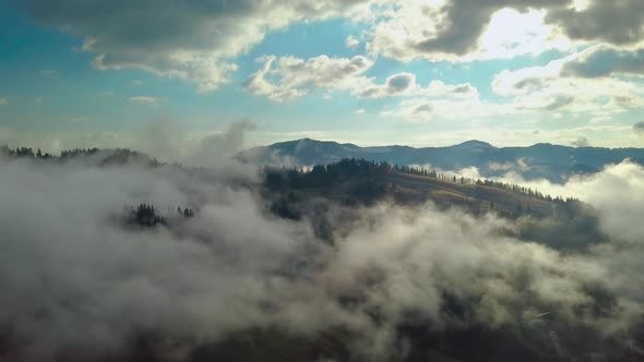 Flying Over a Mountain Landscape in the Clouds