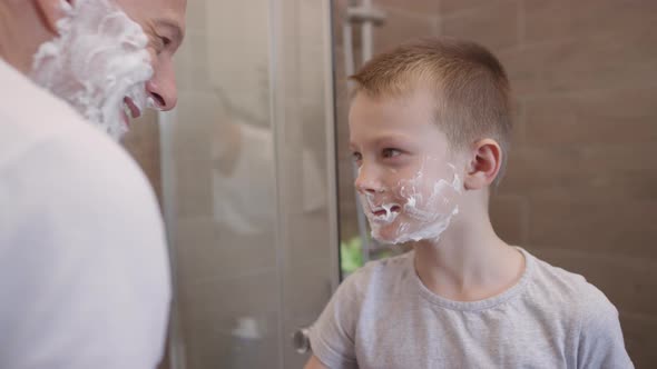Sequence of Man Teaching Son to Shave