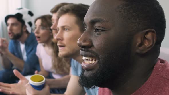 Extremely Excited Football Fan Watching Game With Friends, Decisive Moment