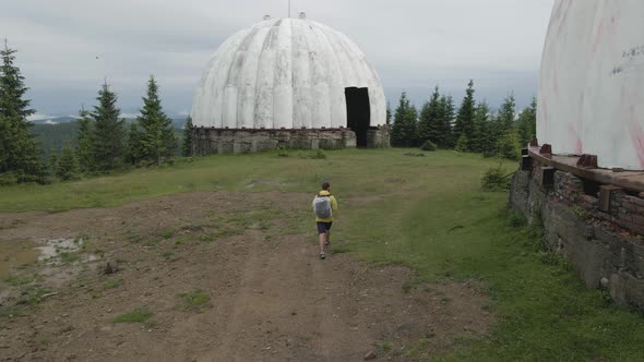 A person exploring around the abandoned soviet radar station in the Carpathians, Ukraine