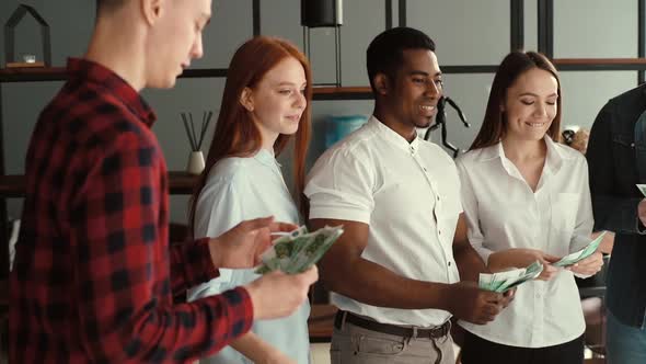 Cheerful Business Team of Young Multi-ethnic Employees Celebrating Victory and Big Profit.