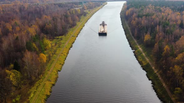 River Tugboat Moves Cargo Barge on the River