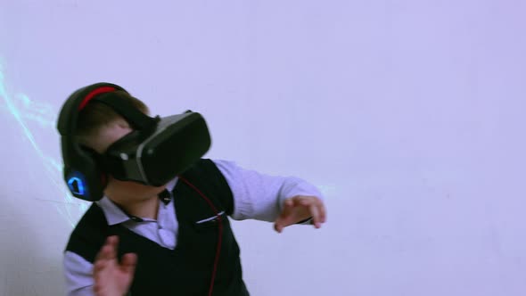 A Boy in an Augmented Reality Helmet Plays and Dodges Virtual Threats