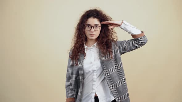 The Young Patriot Serious with Her Hand on Her Forehead Greets Him Like a Devoted Soldier