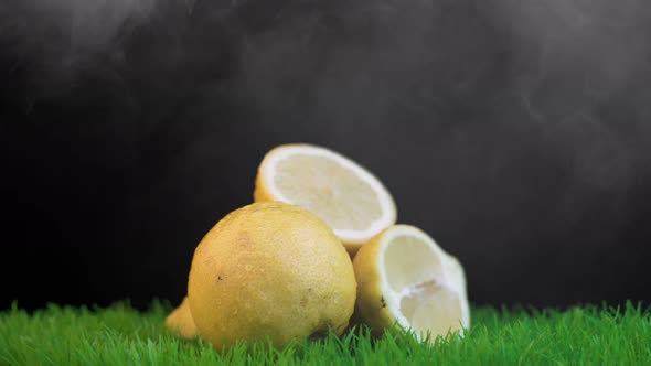 Halves of Organic Yellow Lemons on Rotating Green Surface