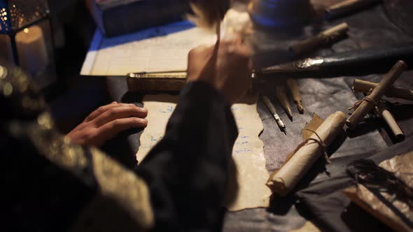 Man writing with a feather pen.