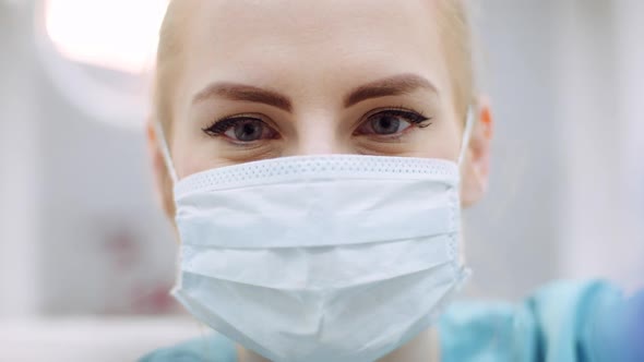 Close Up of Female Dentist Looking at Patient During Surgey