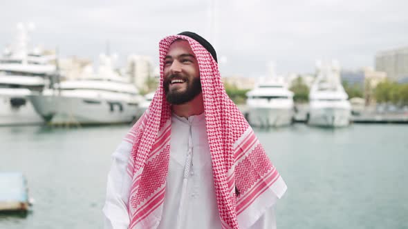 Cheerful Arab Man Walking in Port