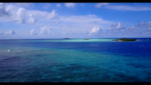 Aerial flying over panorama of beautiful seashore beach vacation by blue lagoon with white sandy bac