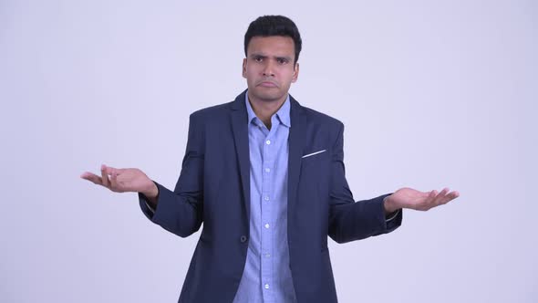 Confused Young Indian Businessman Shrugging Shoulders