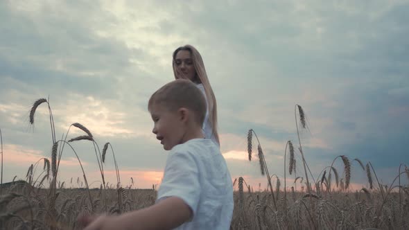 Young Cute Mother and Son in Wheat Field Countryside Nature Woman Enjoy Walks with Her Little Boy