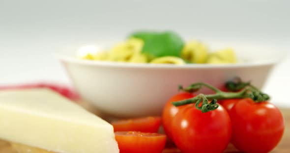 Cherry tomatoes and with bowl of pasta