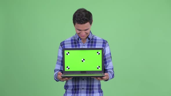 Happy Young Handsome Hipster Man Showing Laptop