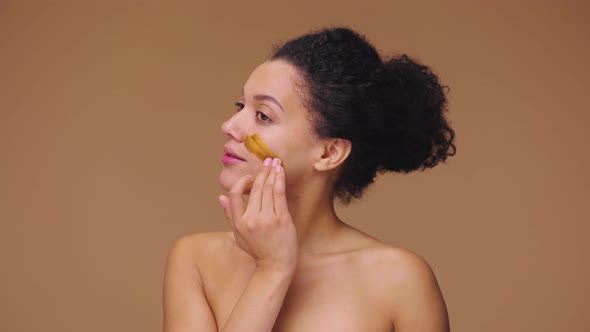 Beauty Portrait Young African American Woman Applying Skincare Scrub on Face Rubbing Gently with