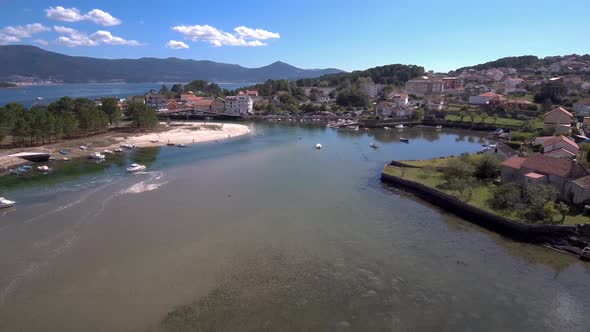 Aerial Dolly Back Over Esteiro Bay With Boats Moored.