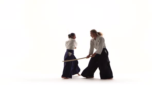 Guy, Girl Demonstrating Aikido Using Bokken. Isolated, White. Close Up