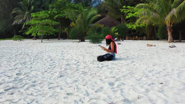 Female models best friends on marine resort beach journey by blue ocean with white sand background o