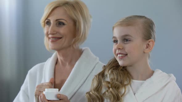 Grandma and Female Kid Admiring Mirror Reflection, Smooth Skin Effect, Cream