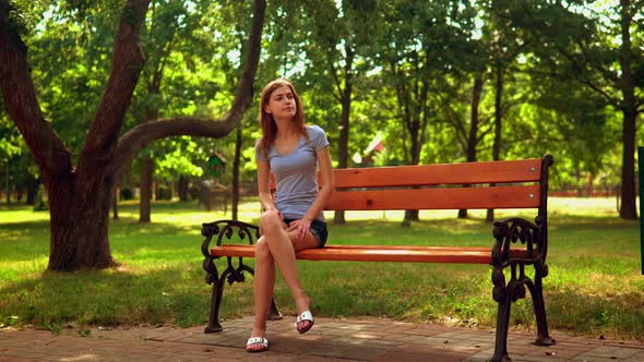 Woman Waiting for Friend in Park