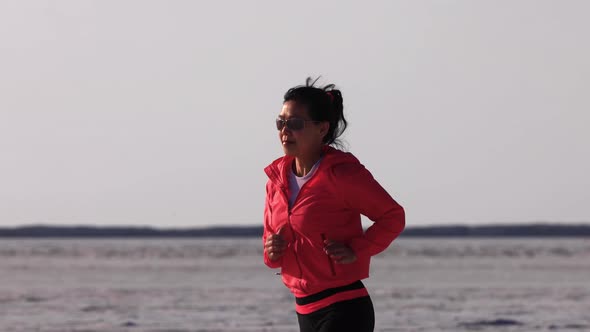 Asian woman jogging across the Bonneville Salt Flats flats