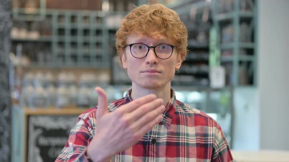 Young Redhead Man Pointing and Inviting