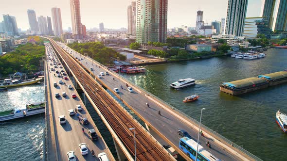 4K : Drones fly over the Chao Phraya River. Aerial view over bts skytrain